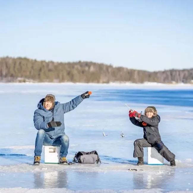 A father and son ice fishing near Westport, Ontario.