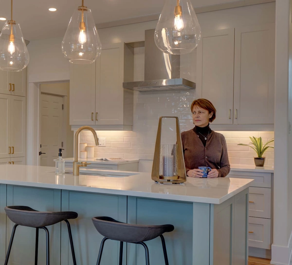 A watercolour resident standing in her kitchen.