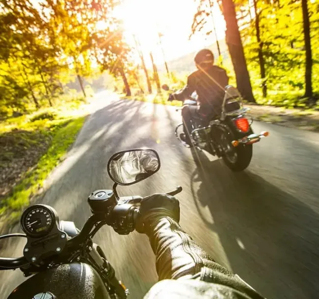Two people motorcycling on some smooth roads close to Westport, Ontario.