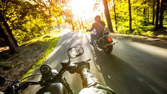 Two people motorcycling on some smooth roads close to Westport, Ontario.