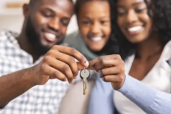 A young family holding the keys to their new home.