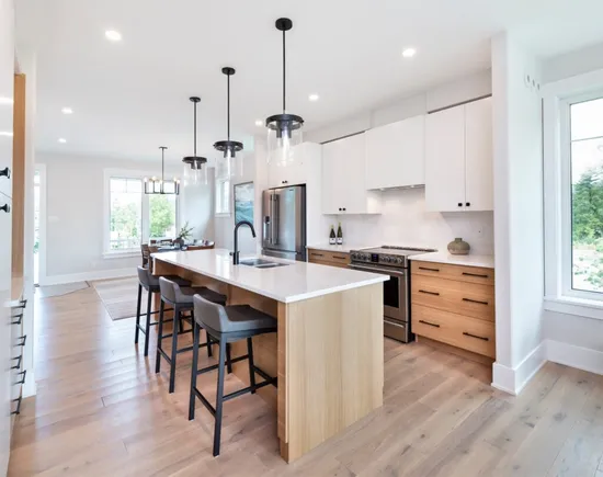 Dining room and kitchen in a home at Watercolour Westport.