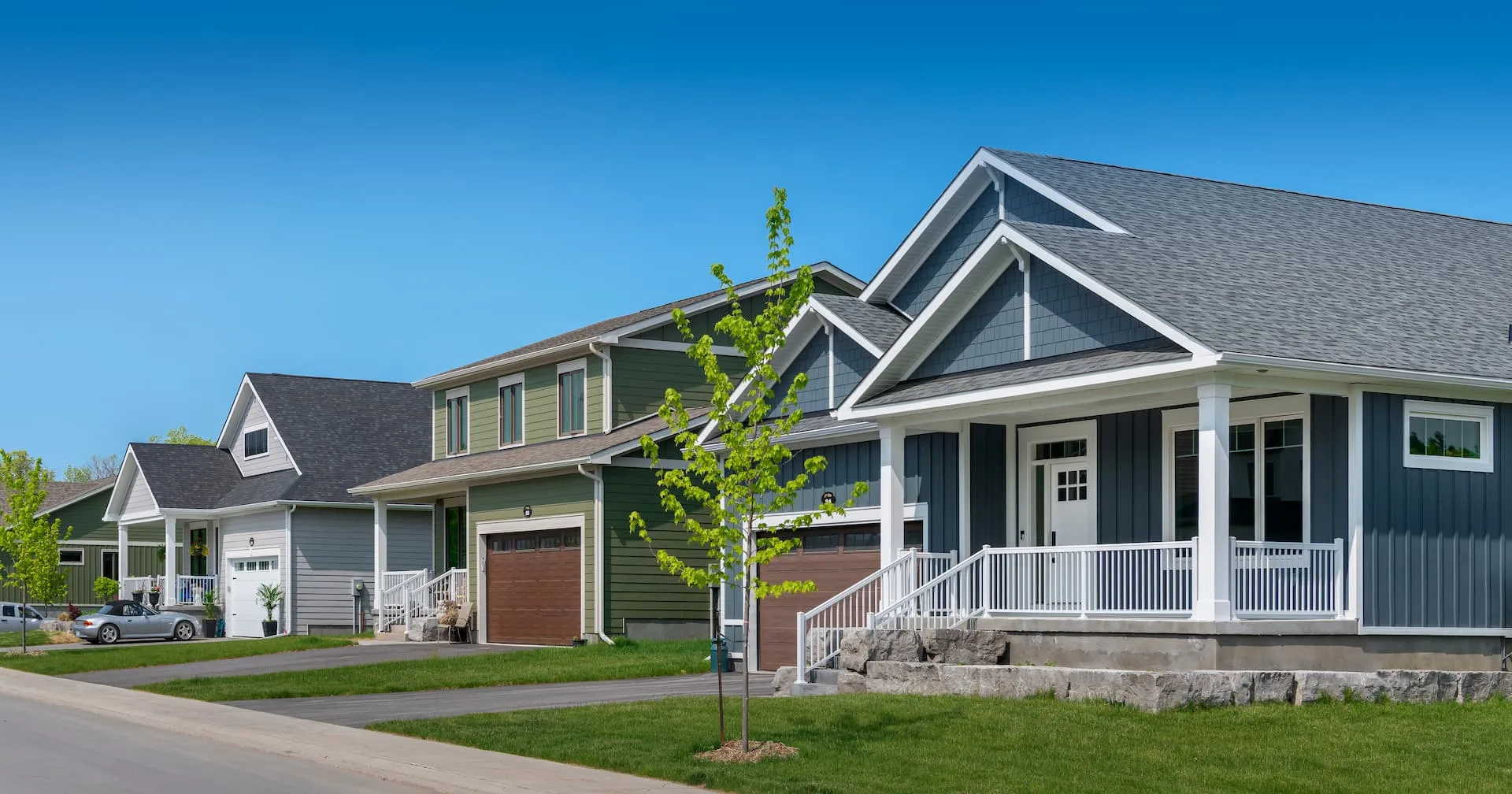 A streetscape of 3 homes in Watercolour Westport.