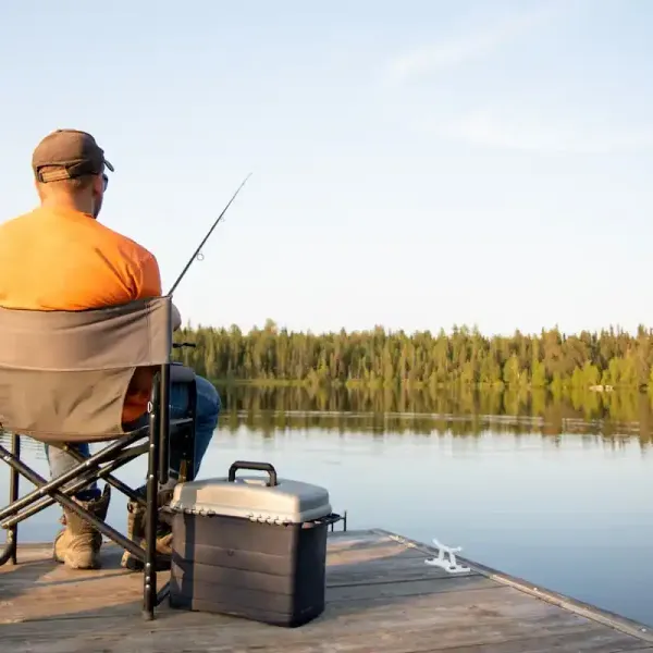 An older man fishing on a dock near Westport.