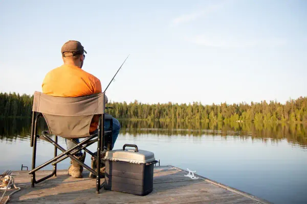 An older man fishing on a dock near Westport.