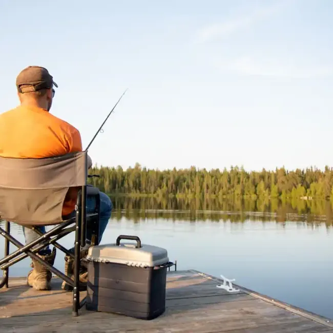 An older man fishing on a dock near Westport.