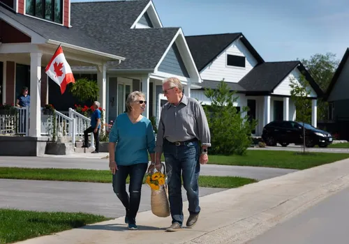 Two elderly residents walking together along cottage style homes at Watercolour Westport.